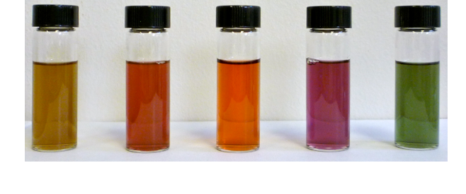 Vials of Au nanomaterials showcasing the different color that is tunable through morphology. The colors shown from left to right are yellow, red, orange, magenta, and green.